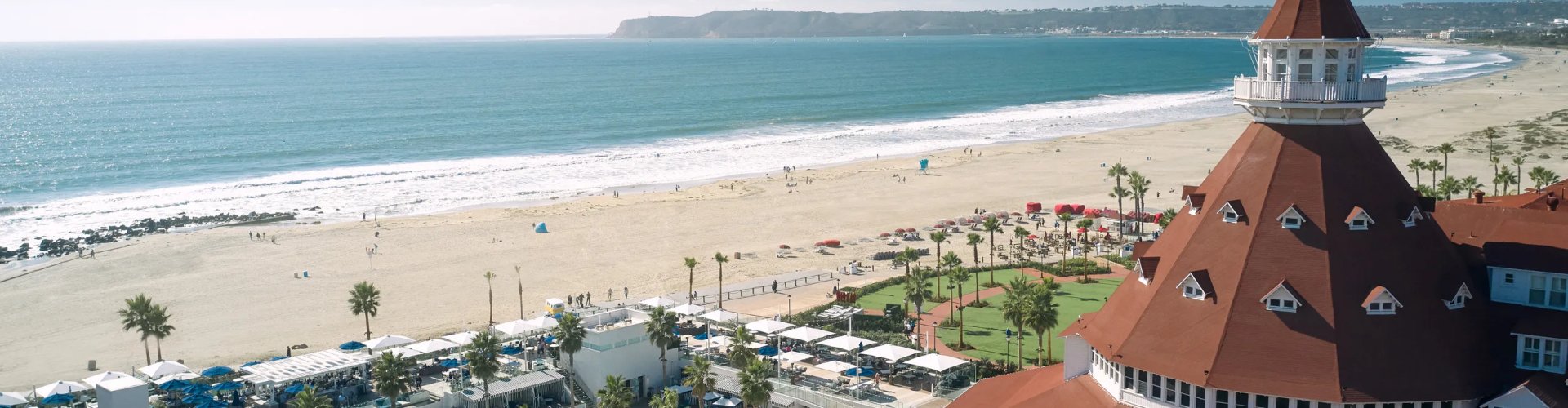 Luxury vehicle cruising Coronado coastline