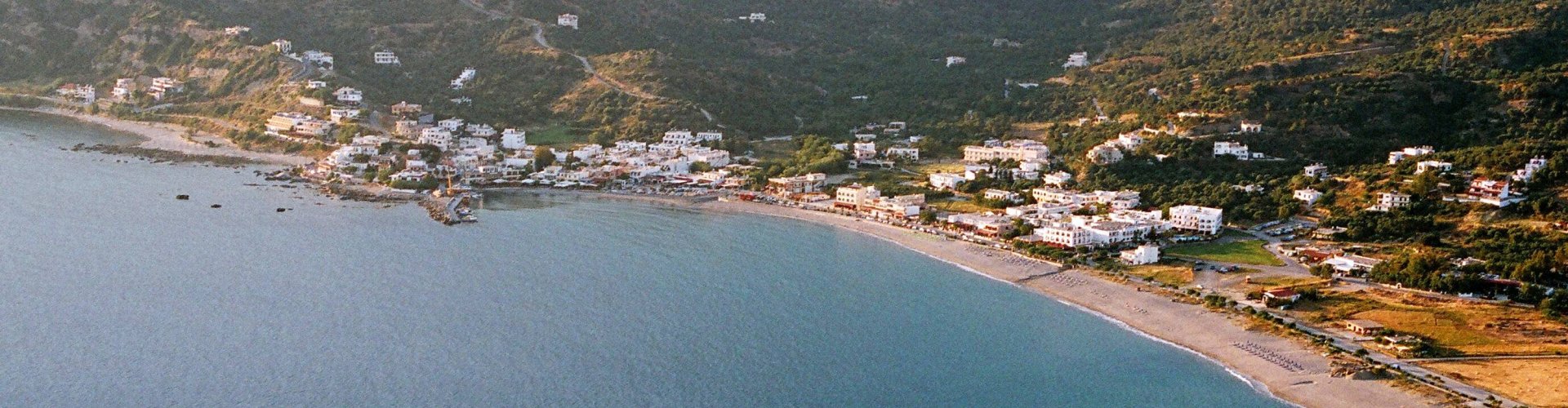 Sunset view over Plakias bay with luxury limousine silhouette