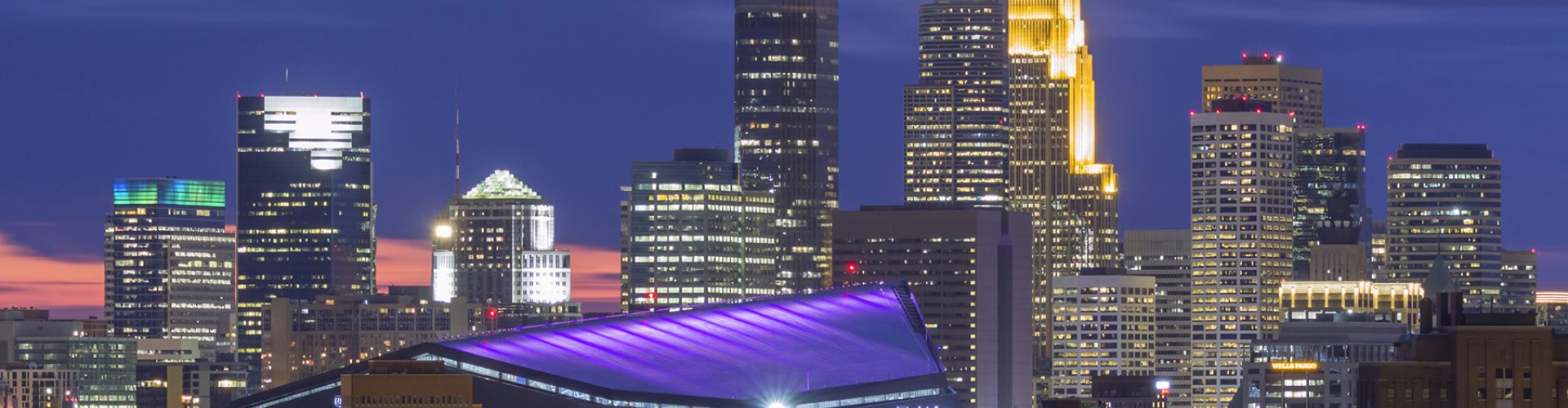 Luxury vehicle parked with Minneapolis skyline