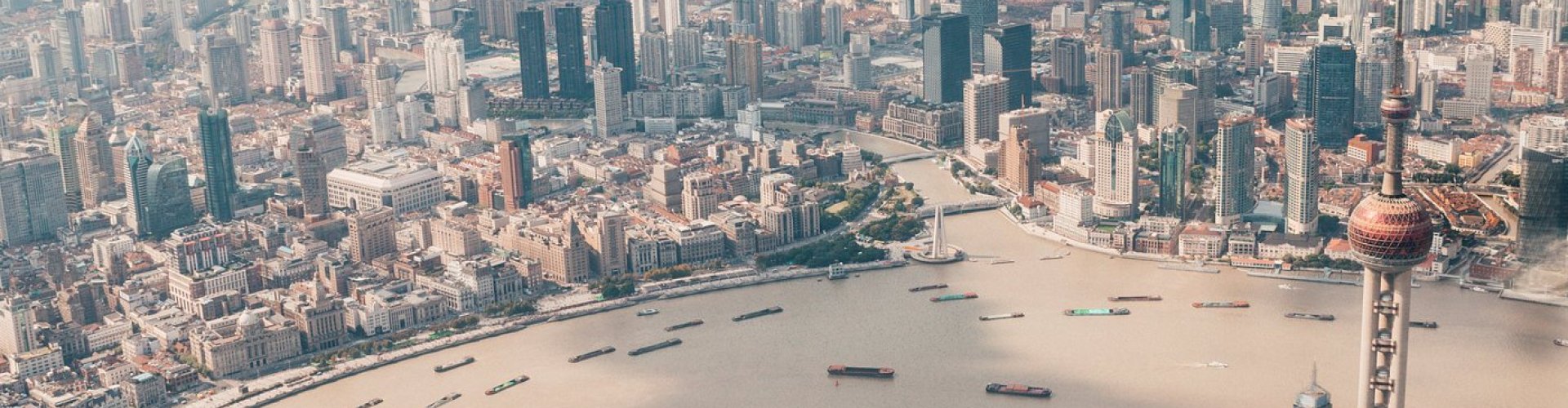 Luxury limo parked against Shanghai skyline